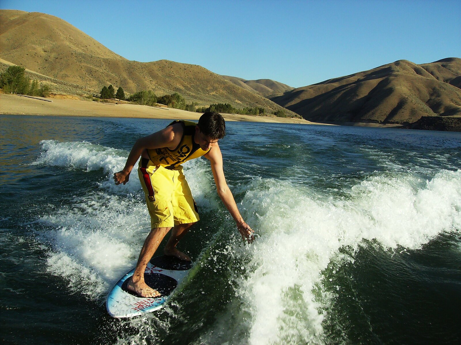 Wakesurfer on Lucky Peak Reservoir below the Boise foothills, Southeast Boise