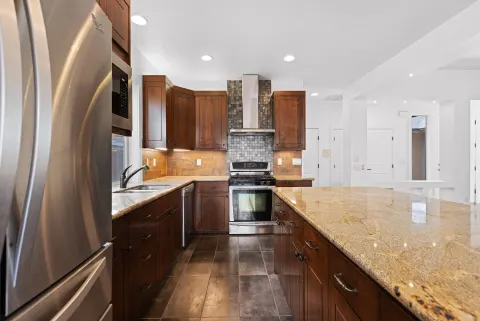 Kitchen, granite island and stainless appliances