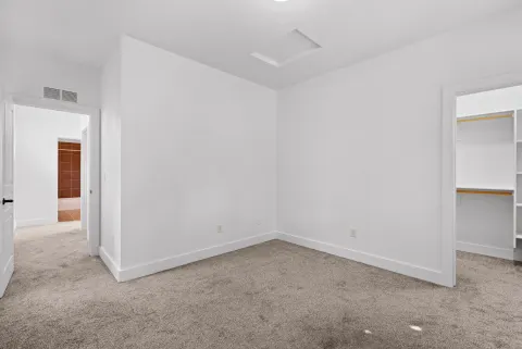 Carpeted room beside the hall bathroom