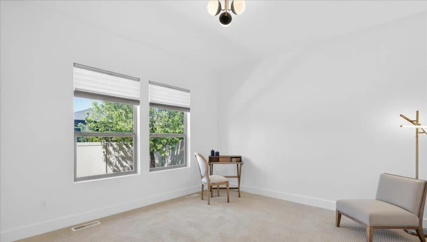 The flex room at 2377 S Aburge Ave as photographed: empty, two windows, sloped ceiling