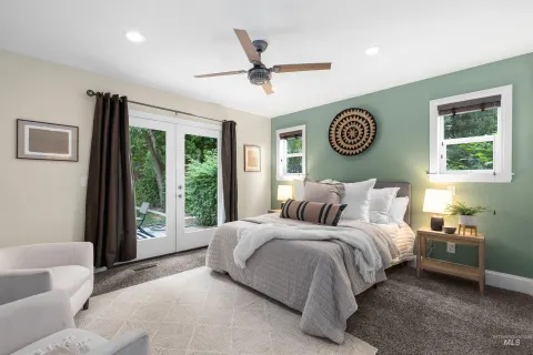 Main-level primary suite, French doors to the patio